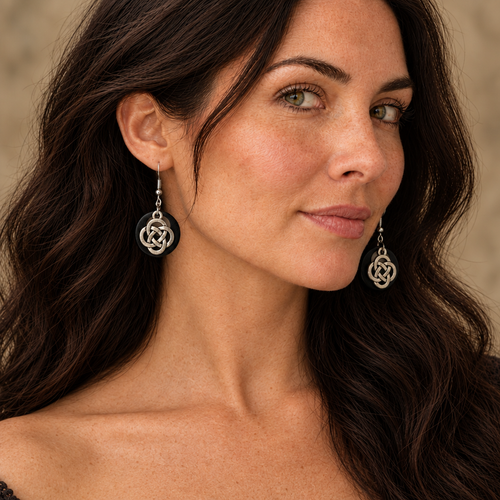 Close-up of the model wearing black and silver Celtic knot earrings